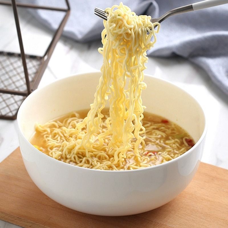 White porcelain soup bowl filled with noodles lifestyle food shot

