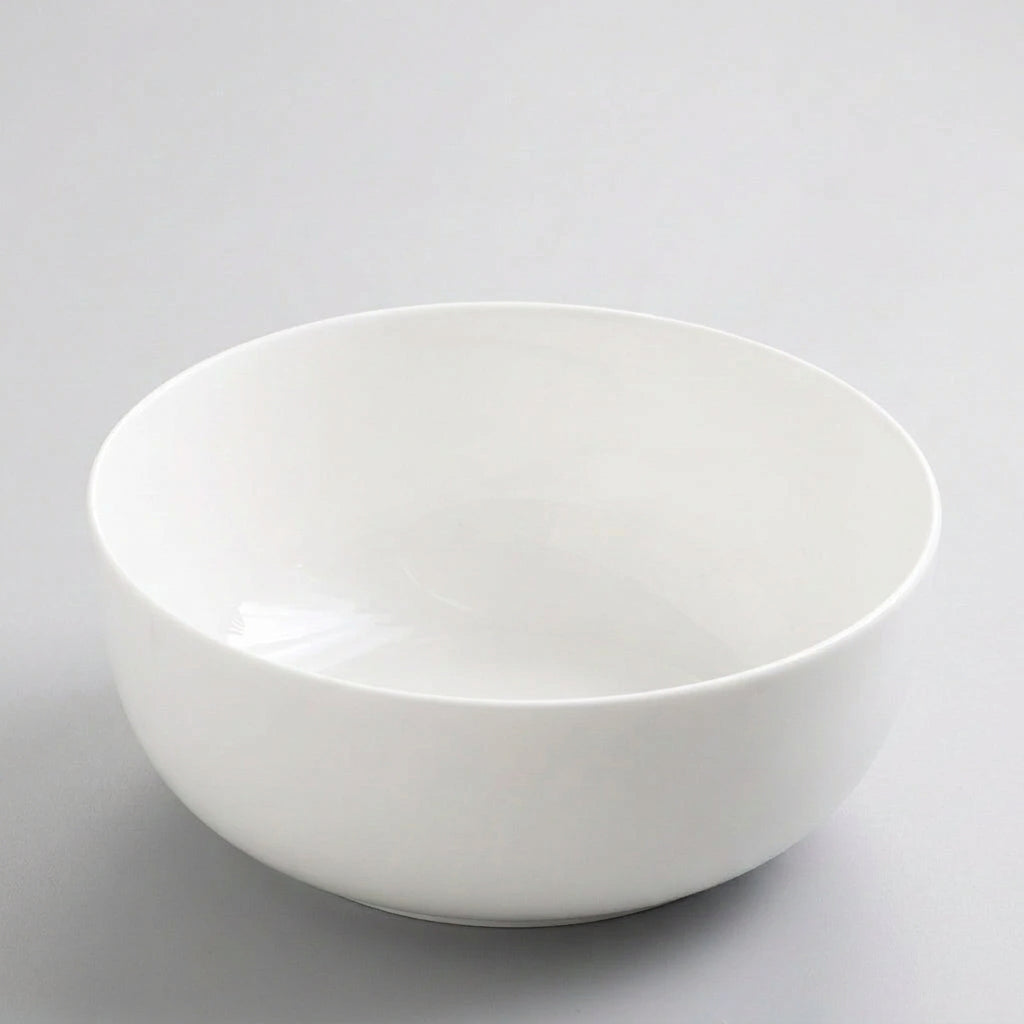 White porcelain soup bowl overhead angle on white background
