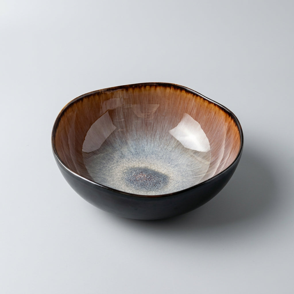 Flame glaze ceramic irregular soup bowl on dark background product shot
